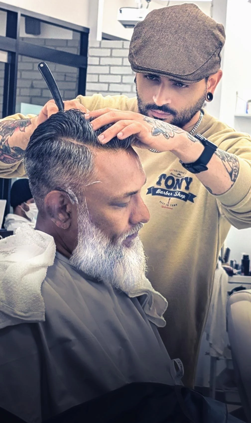 TONY barber working on a guest